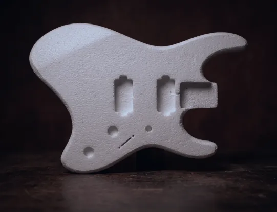 Thermocol prototype body with two pickup routes, on a dark wooden surface.
