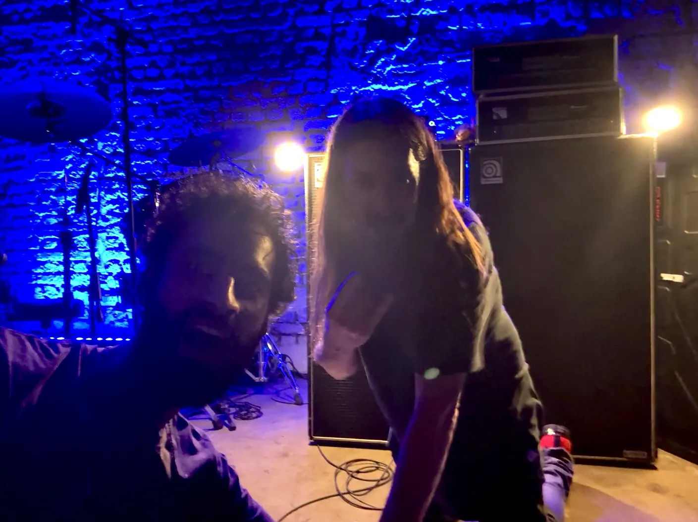Selfie with Bryan Beller at a venue lit in deep blue.